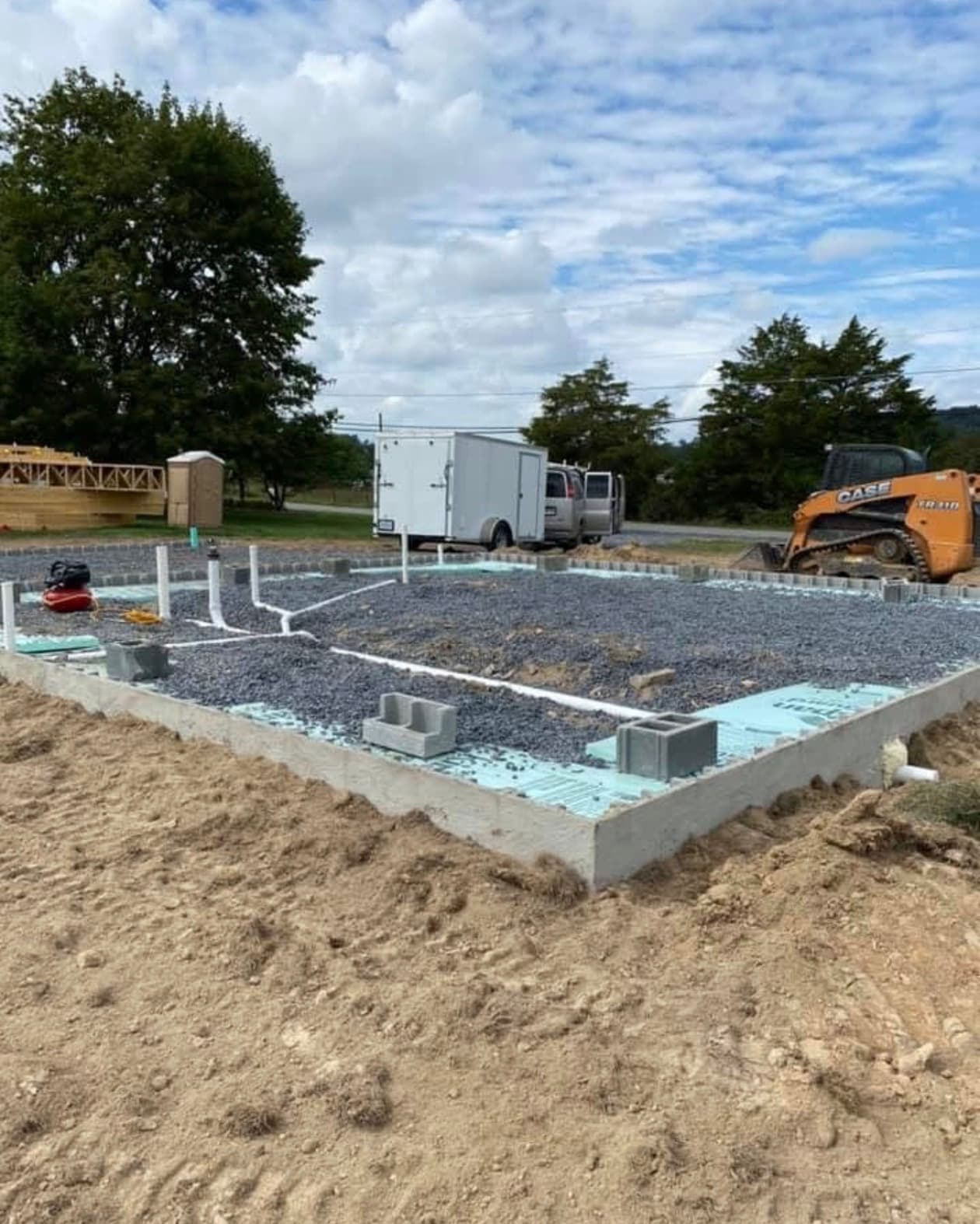 Under-slab waste line run and graded before the concrete pour