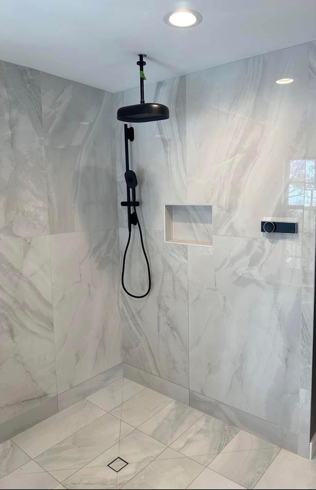 Tiled walk-in shower with rain head and handheld, finished remodel